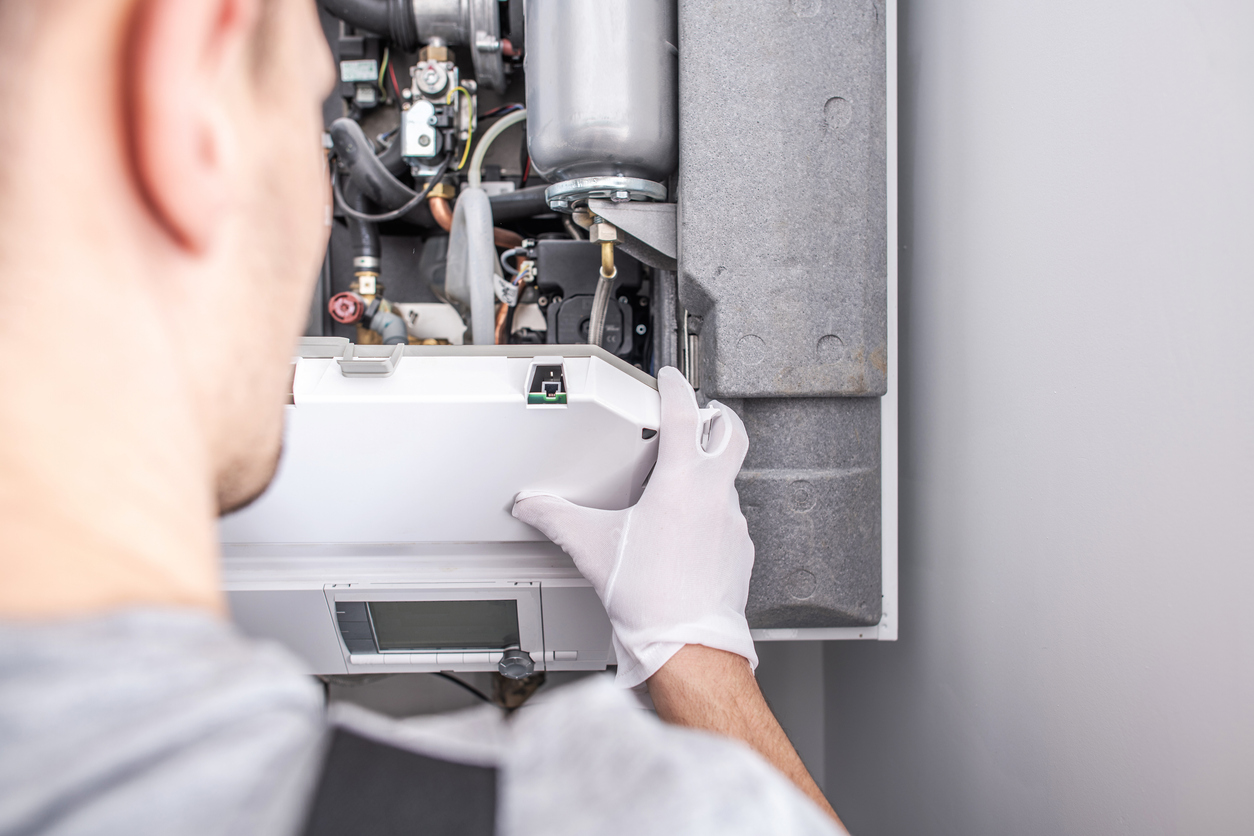 HVAC technician repairing furnace